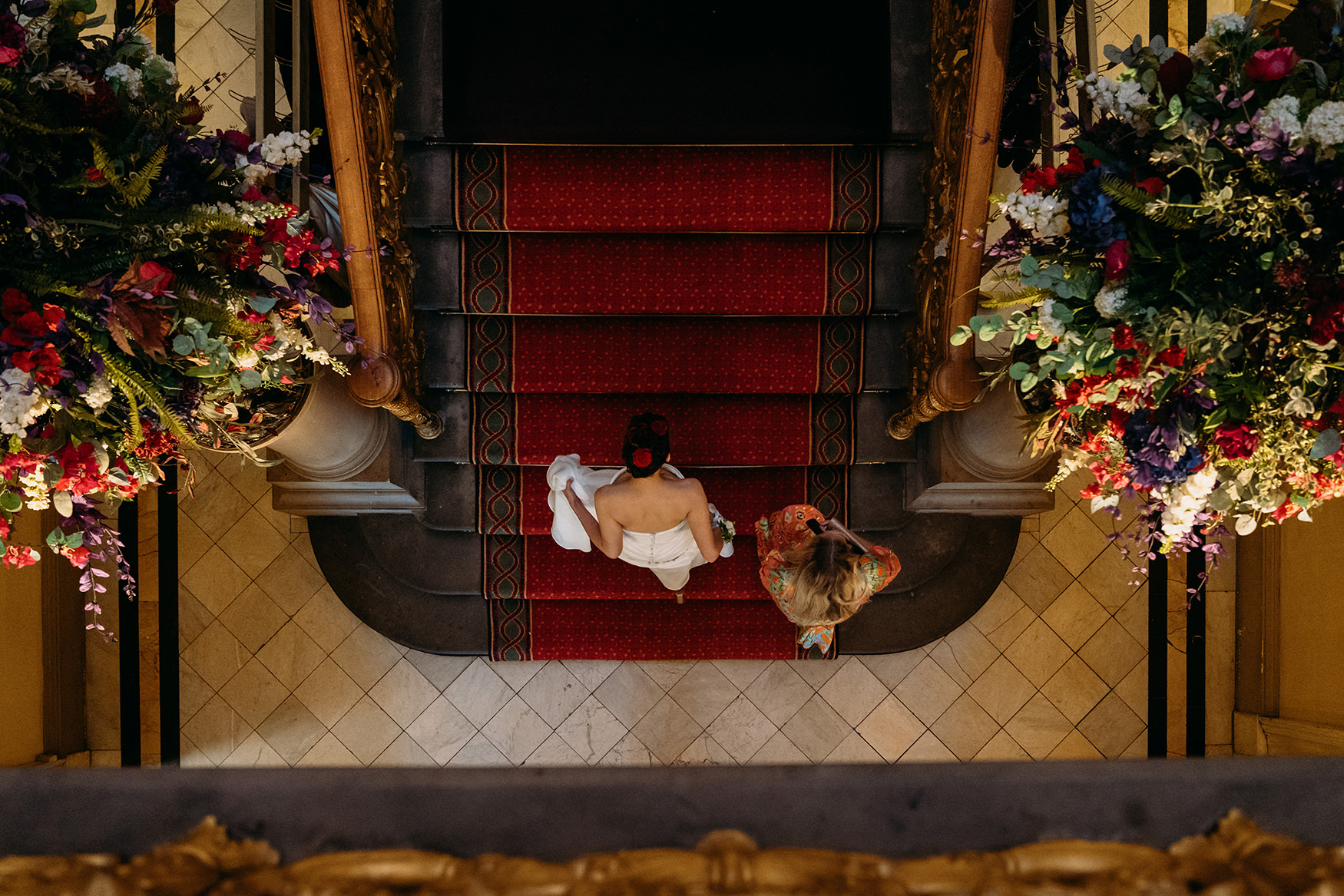 bride walks up a grand staircase to her ceremony at Royal College of Physicians Wedding