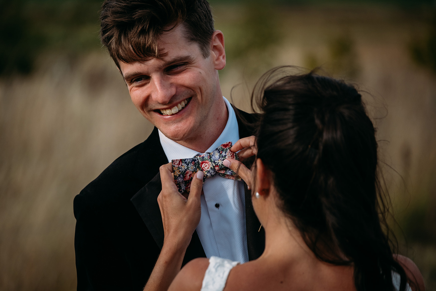 bride fixes grooms bow tie