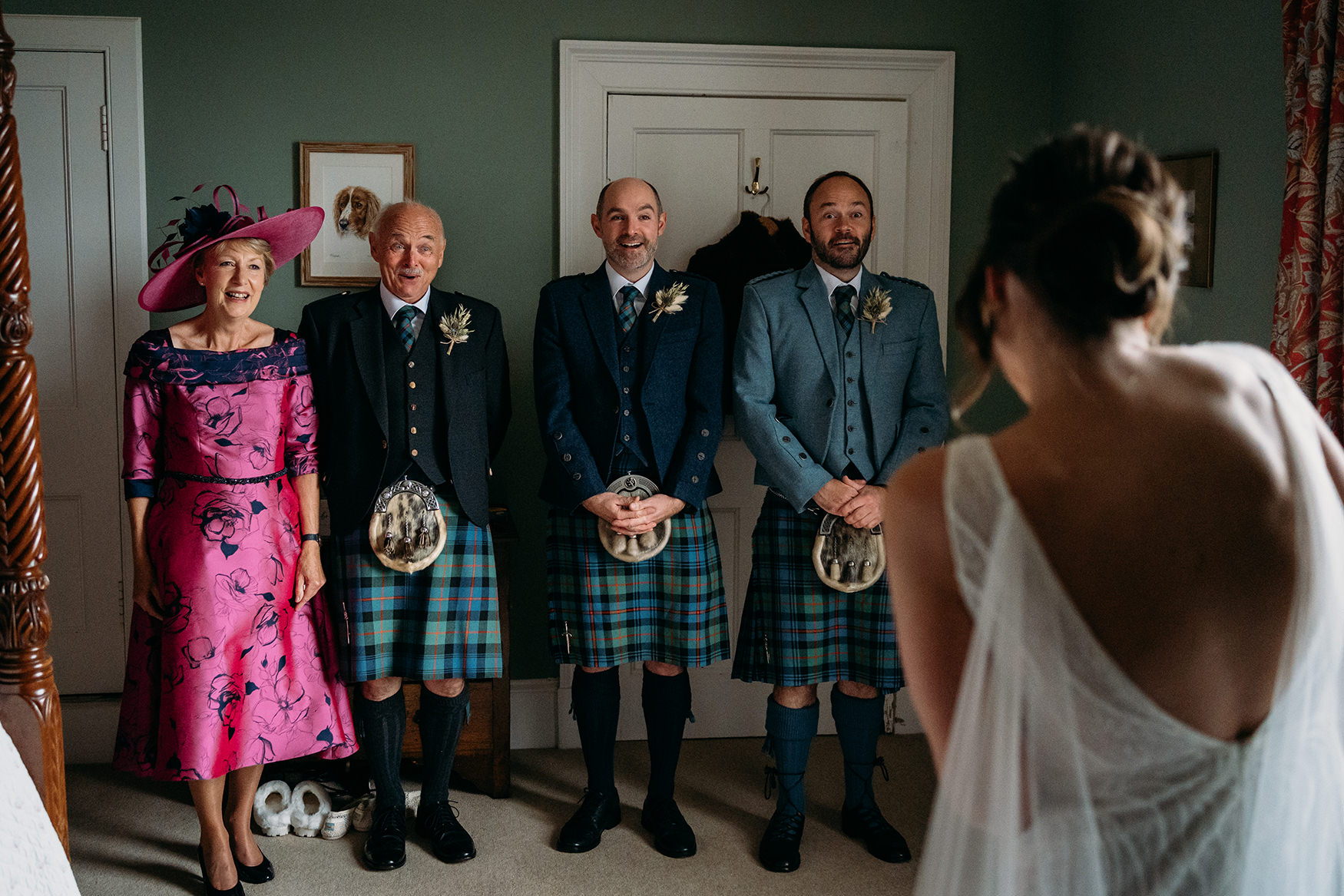 photo of family seeing bride in her dress for the first time for a blog about making sure to back up your wedding photographs