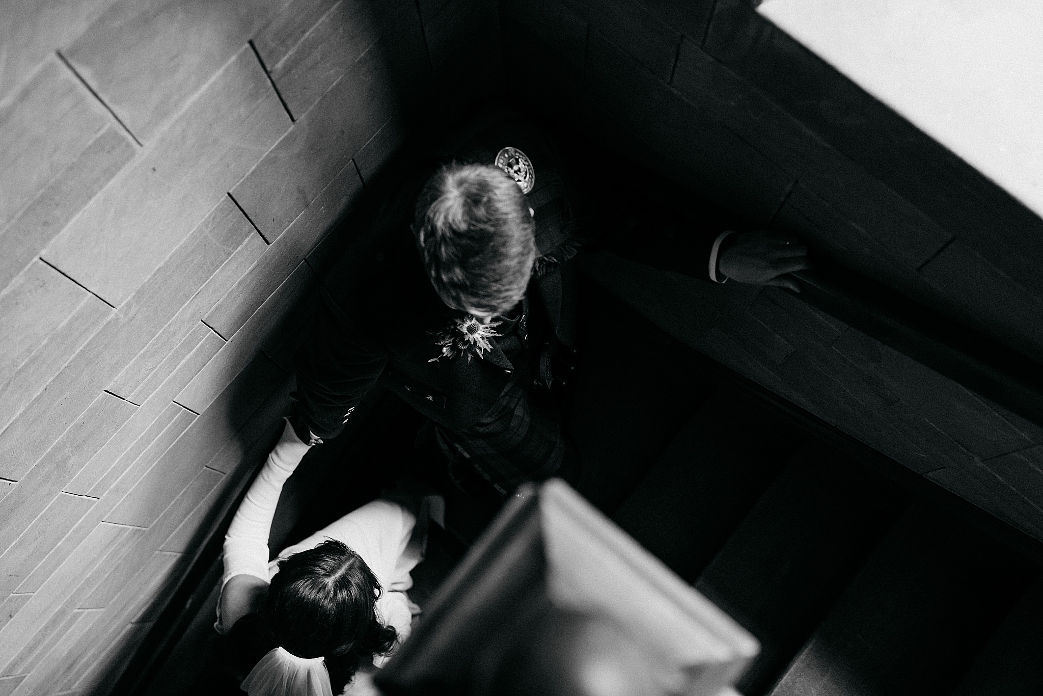 birds eye view of groom leading bride up stairs at Indo-Scottish Achnagairn Castle wedding