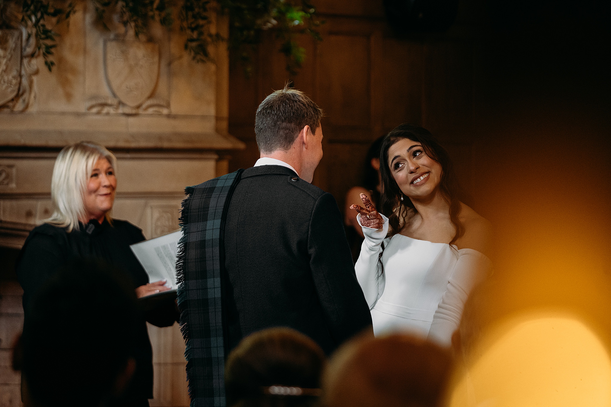 Bride pulls funny face at Groom during Humanist ceremony at Indo-Scottish Achnagairn Castle wedding