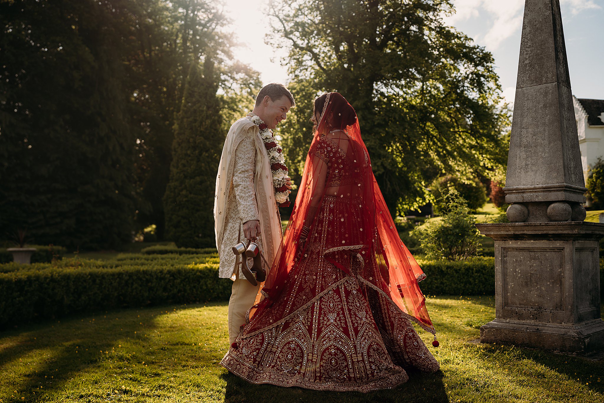 Bride spins in golden hour as Groom holds her shoes during their Indo-Scottish Achnagairn Castle wedding