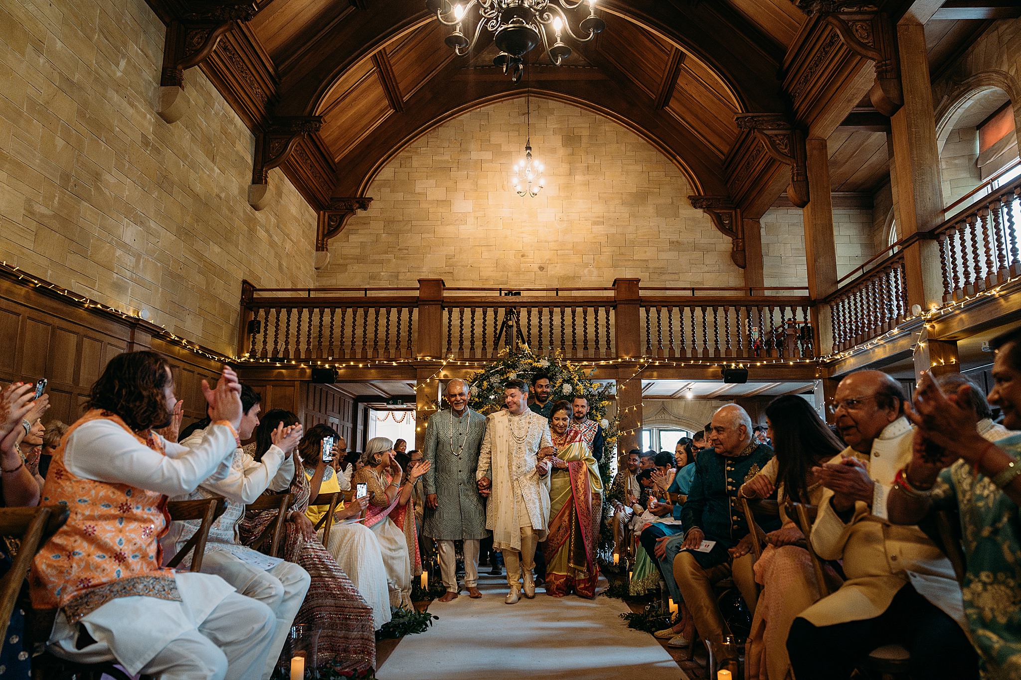 Groom walked into Indo-Scottish Achnagairn Castle wedding ceremony by brides Mum + Dad