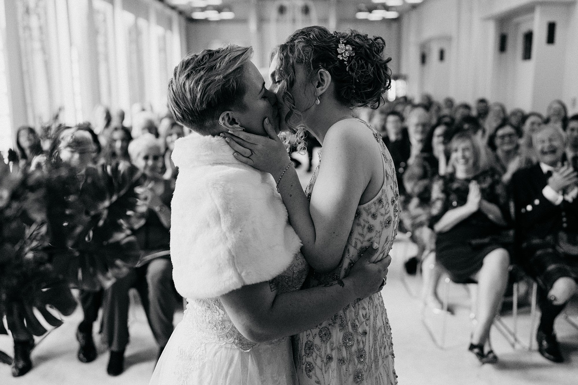 Two brides kiss at House for an Art Lover. relaxed wedding photography in Glasgow
