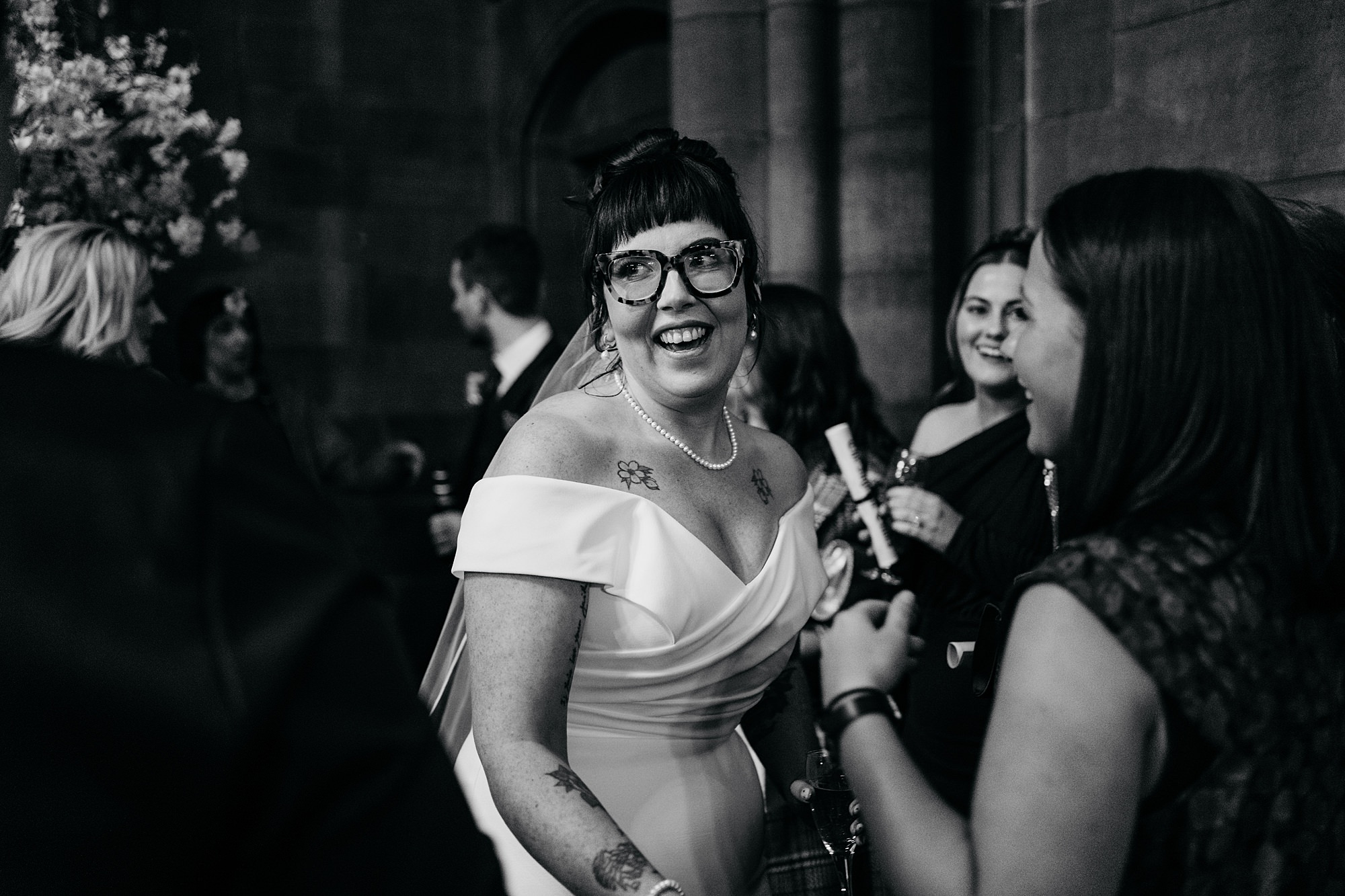 Smiling bride greets guests at Coats Paisley twilight wedding. relaxed wedding photography