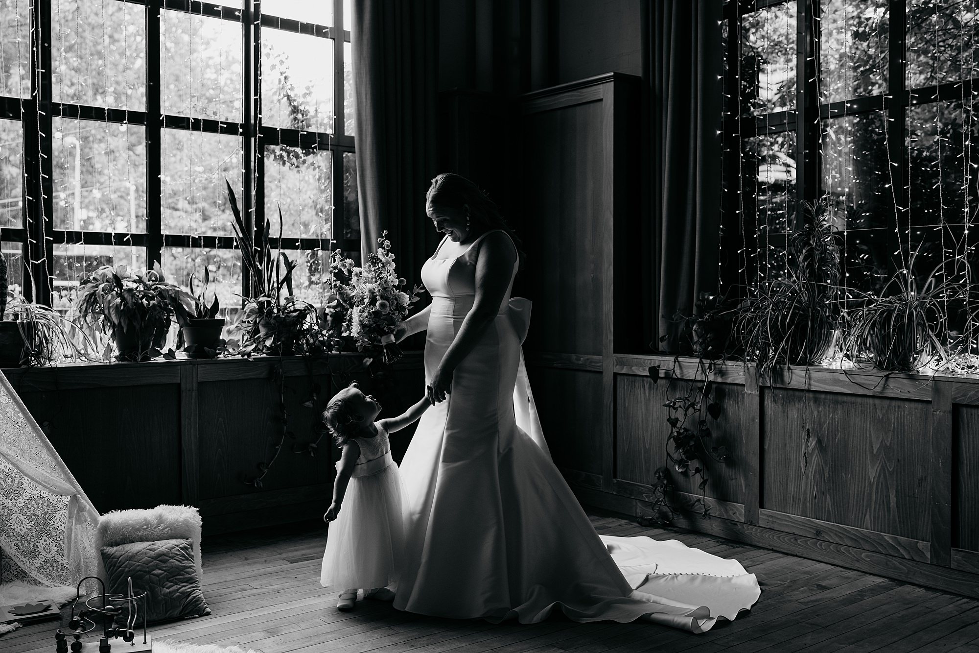 A bride and her little daughter share a look before the Mums wedding. Relaxed wedding photography at West Beer in Glasgow.