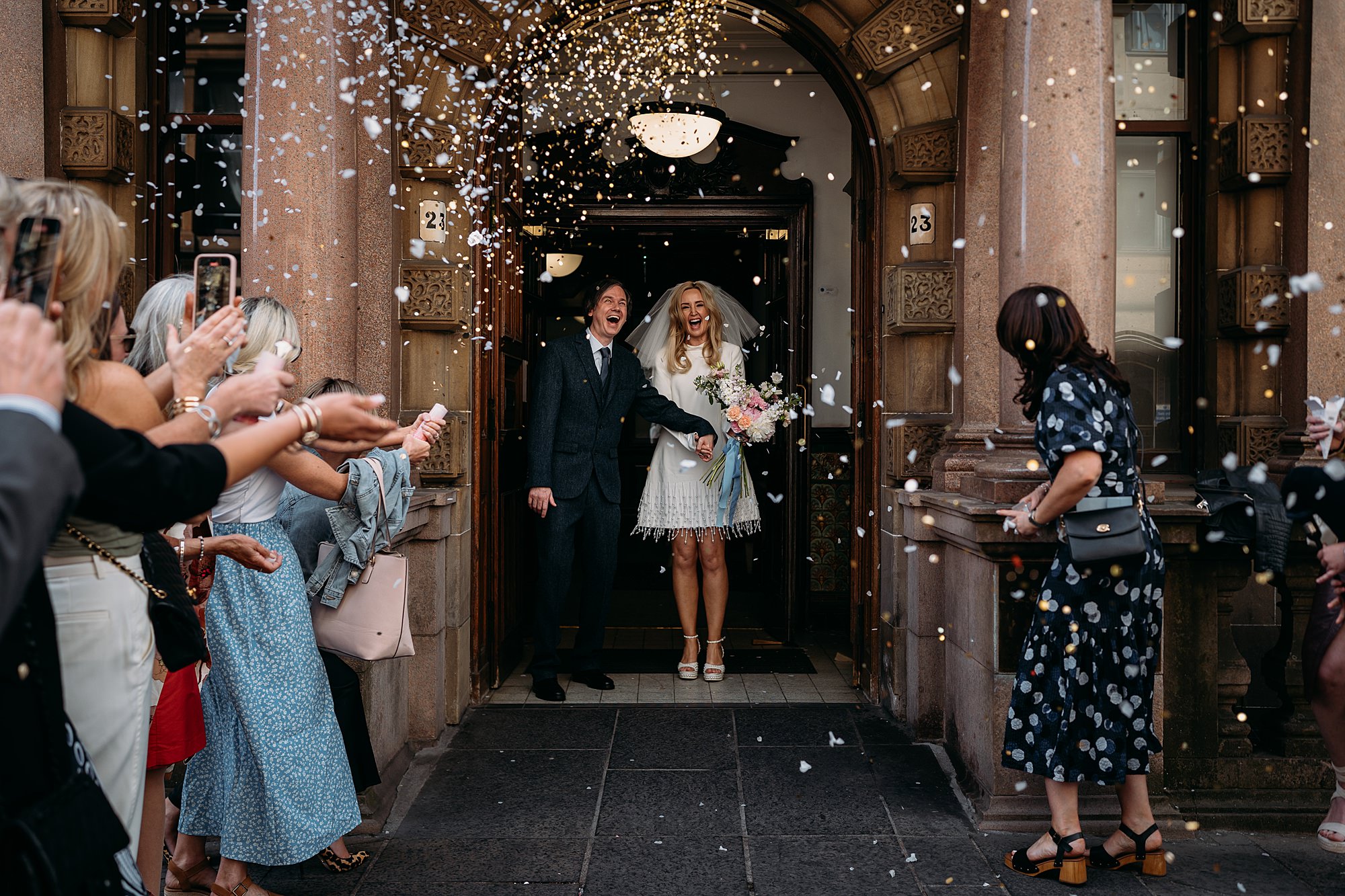Couple surprised by confetti after their Montrose Street wedding. relaxed wedding photography in Glasgow