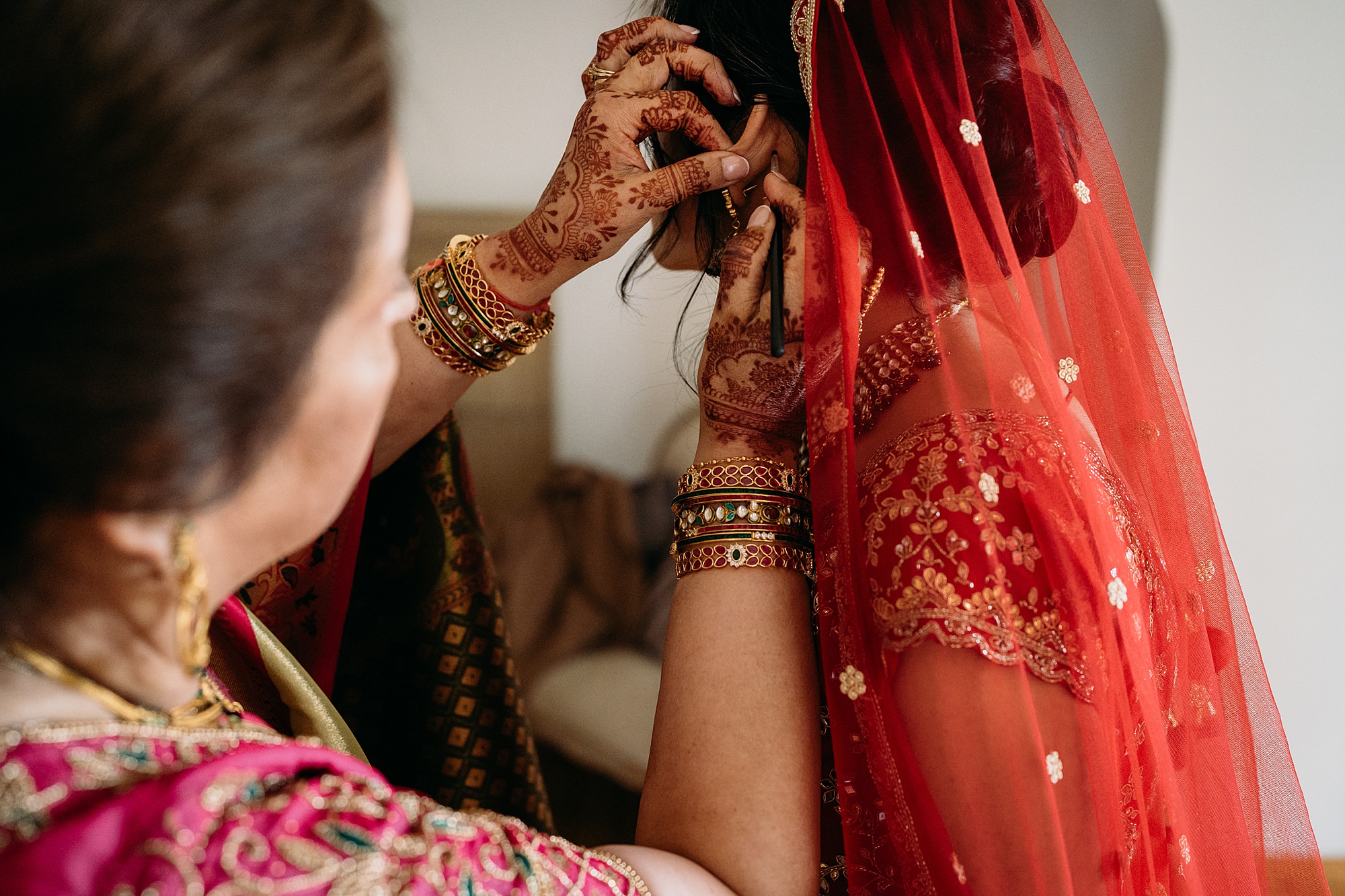 Mother wards of bad luck for daughter. Relaxed wedding photography at Achnagairn Castle, and Indian Scottish wedding.
