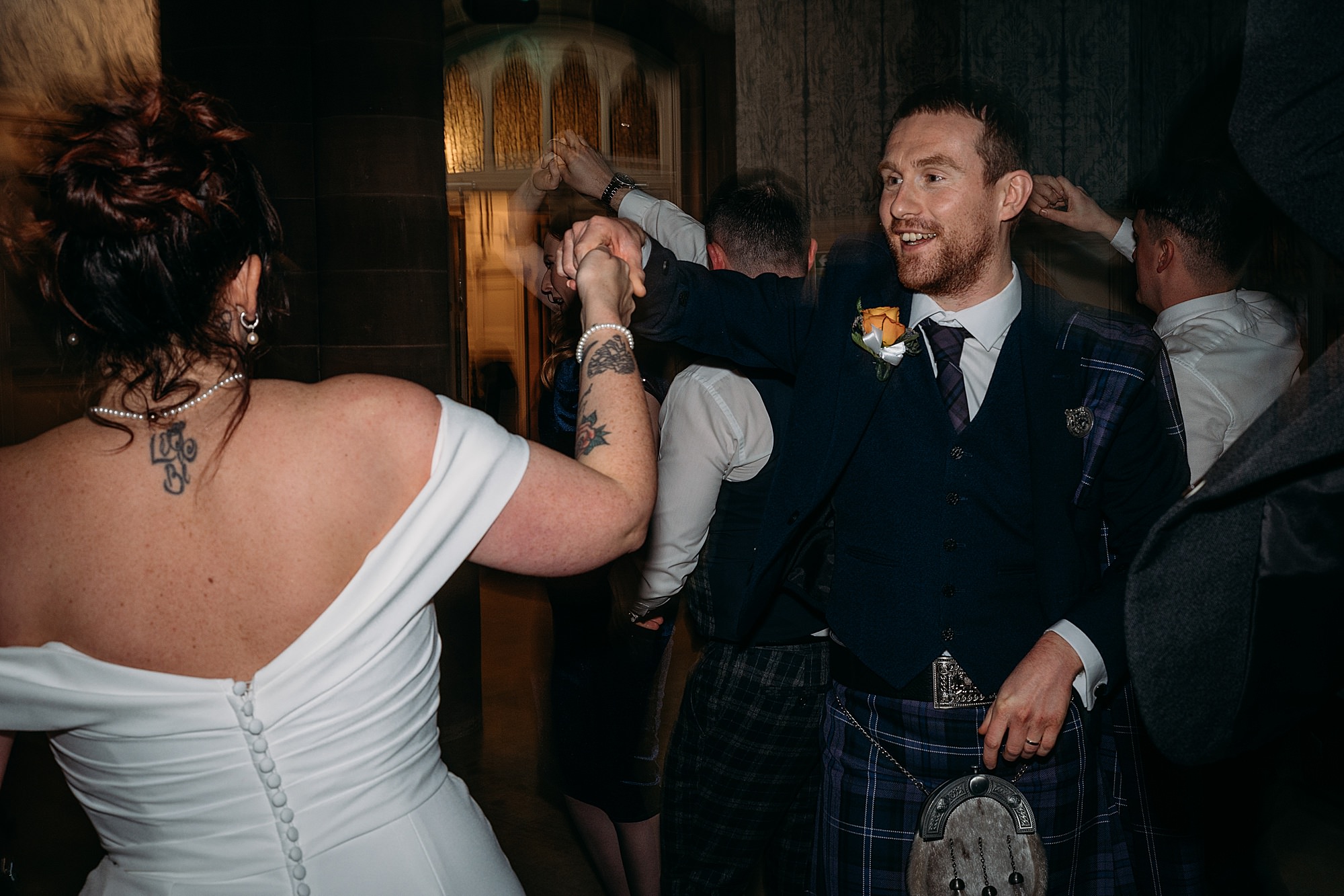 groom spins bride at Coats Paisley Twilight Wedding party