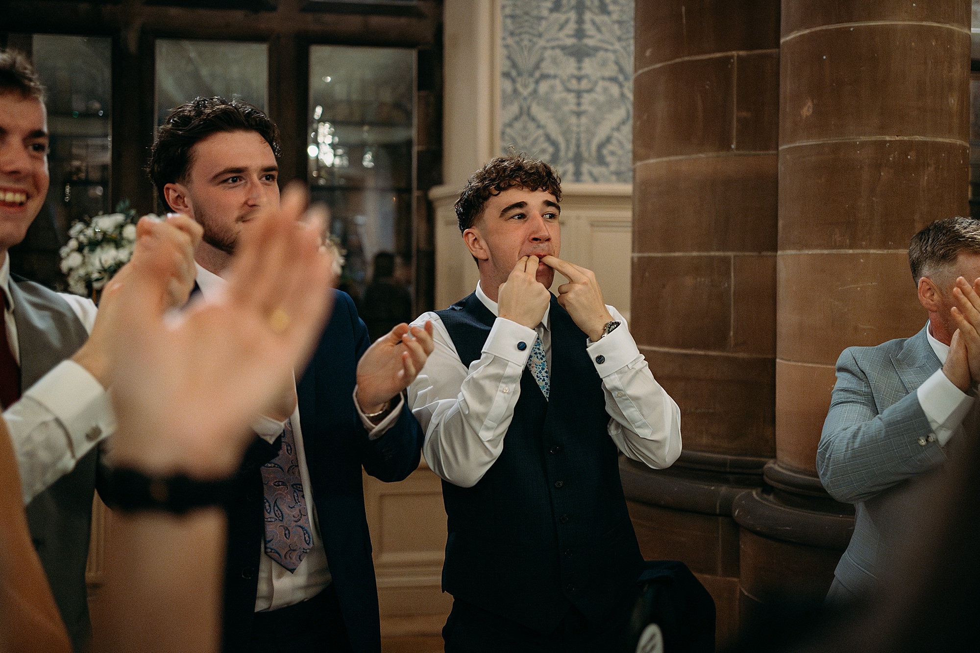 Male guest whistles as bride and groom make their entrance at Coats Paisley Twilight Wedding