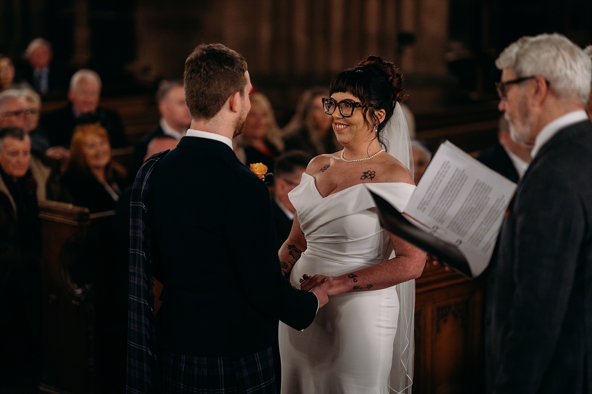 Bride smiles at Groom at Coats Paisley Twilight Wedding ceremony