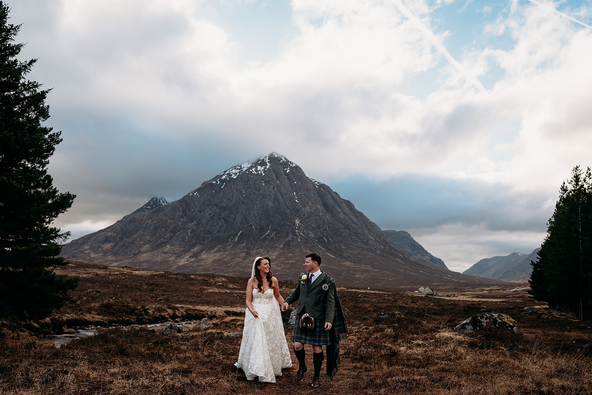 Newlyweds surrounded by the dramatic Highland landscape at Kingshouse Hotel Glencoe.