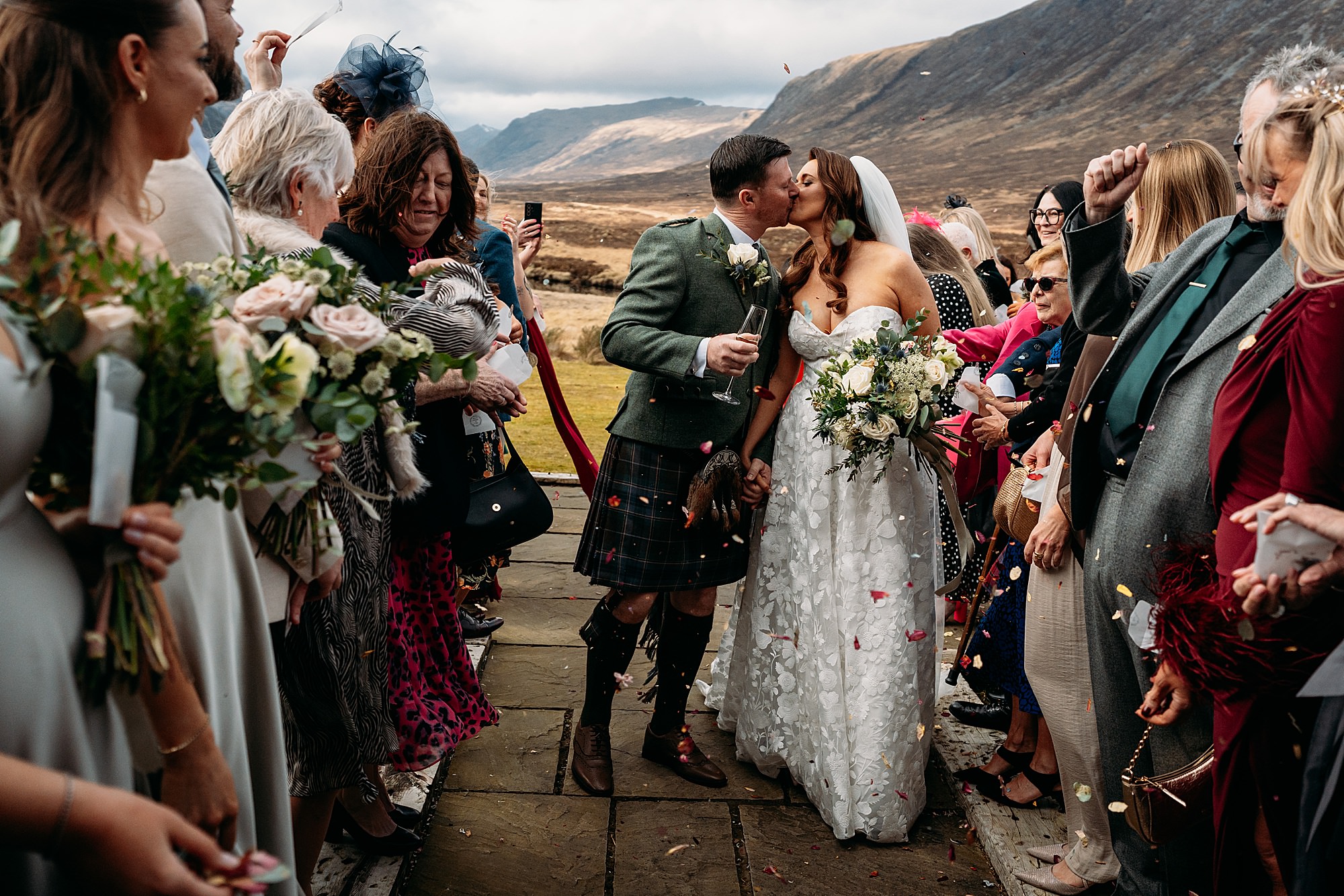 Couple kiss as wedding guests throw confetti at Kingshouse Glencoe wedding